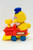 Sesame Street Big Bird Wind Up Toy Train, yellow Big Bird character with a blue hat riding on a red and yellow toy train with blue wheels.