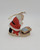 Roman Inc Vintage 1985 Roman The Kneeling Santa Ceramic Ornament, a detailed depiction of Santa Claus kneeling in prayer beside a manger with baby Jesus, crafted with colorful paint and a gold string for hanging.