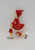 Vintage female Santa ice skater Christmas ornament by Delta Novelty Co. The ornament was made in Japan and stands about 5-inches tall wearing red dress, pants and hat.  The skater also has a white beard.