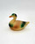 Vintage Celluloid Mallard duck toy figure that is 3-inches long.  The duck has green head, chest and tail feathers. The rest of the body is brown in color.