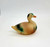 Vintage Celluloid Mallard duck toy figure that is 3-inches long.  The duck has green head, chest and tail feathers. The rest of the body is brown in color.