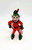 Rosbro Vintage Rosbro Hard Plastic Elf Christmas Ornament, vintage elf figurine with red and green attire, elf's face with painted features, holding a small pink mouse, on a plain white background.