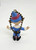 Memory Lane Rudolph the Red Nosed Reindeer Boy Elf Key Chain, figurine of a boy elf with a blue hat and outfit, holding a ball chain loop.