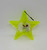 Unknown Vintage Yellow Plastic Star Spinner Christmas Ornament, bright yellow star-shaped decoration with glitter and a small spinning mechanism inside.