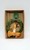 Commodore Vintage Commodore Battery Operated Blinking Christmas Wreath, a decorative holiday wreath made of green leaves with red berries, a yellow ribbon, a candle with a flame, and bells, made in Japan.
