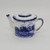 Miniature teapot by EBC Foley that stands 2.25-inches tall.  The white teapot has a scene of a country farm in blue on one side and plain on the other side.