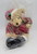 AVON 2001 Sammy Santa Teddy Bear, a plush Santa-themed teddy bear with a red outfit and black shoes, inside a clear plastic bag.