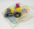 Wendy's Kids' Meal Toy 1997 Wendy's On Wheels - Soft Drink Cup, colorful miniature toy drink cup with lid and straw, packaged in a clear plastic bag.