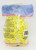 Greenbrier International Easter Grass - Yellow, yellow decorative Easter grass in a clear plastic bag with pink striped border and barcode.