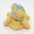 Enesco 1996 Little Sparkles March Bear Figurine, a small, yellow, textured bear sitting with a light blue ribbon tied around its head.