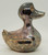 Unknown Vintage Silver Plated Duck Bank, a metallic coin bank shaped like a duck with a shiny, tarnished surface and hollowed-out openings for coins.