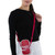 Comeco Officially Licensed Coca-Cola Hero Cross Body Bag, red and white Coca-Cola branded purse worn across the shoulder of a woman in a black top and white pants.
