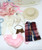 Vogue Dolls The World of Ginny Wardrobe and Accessories Playset, assorted doll clothes and accessories including a pink dress, white sweater, beige stockings, a small purse, a pink bib, a cream hat, and additional clothing items.