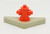 Fisher Price Original Little People Sesame Street Playset - Fire Hydrant, vintage red fire hydrant toy on a beige rectangular base.