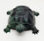 Sterling Plastic Turtle Pencil Sharpener - Green, detailed close-up of a green plastic turtle-shaped pencil sharpener with textured shell and small limbs, on a white background.