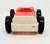 Fisher-Price Original Little People 1-Seat Garage-Style Car - Red Top White Base, a toy red and white plastic car with black wheels designed for children's play.