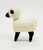Fisher-Price Original Little People Sheep Woolie the Sheep, a small interactive toy with a white and black sheep design and a textured body.