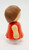 Playmates Li'l Playmates - Female with Orange Dress and Brown Hair, plastic toy figure from the back view.