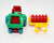 Playmates 1985 Li'l Playmates Farm Play Set - Tractor with Disc Plow, colorful plastic toy tractor in green, red, blue, and yellow with attached disc plow and additional yellow attachment, suitable for children's farm play.