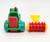 Playmates 1985 Li'l Playmates Farm Play Set - Tractor with Disc Plow, colorful toy tractor and plow attachment on a white background.
