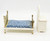 Fisher-Price Doll House Decorator Set #255 Bedroom, miniature white bed with gold metal frame and blue floral mattress, and white dresser with a mirror.