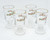 Libbey Glass Company Libbey Christmas Green and Red Holly Irish Coffee Mug Set of 4, clear glass mugs with holiday holly and berry design, gold rims, and handle, perfect for festive occasions.