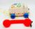 Fisher-Price 1985 Chatter Telephone, vintage children's toy with a white rotary phone design, colorful star decorations, blue wheels, and a red carry handle.