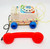 Fisher-Price 1985 Chatter Telephone, vintage toy with a colorful star pattern, blue wheels, and a rotary dial, featuring a red receiver and yellow cord.