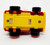 Russ Berrie & Co RUSS SL Red Hair Troll Driving Fire Truck Pull Back Toy, underside view of the toy showing yellow, red, and black plastic parts with construction details.