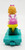 McDonald's Happy Meal Toy 1994 Ronald McDonald's Happy Birthday #6 Berenstain Bears, back view of a plastic figure of a girl with blonde hair in a pink dress sitting on a yellow skateboard with a teal base.