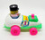 AMLOID Corp AMLOID Jumpin' Jimmy Racer Pull Toy, colorful vintage toy car with a clown figure on top, featuring pink wheels and bright green and pink details.