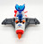 Fisher-Price® Imaginext® 2014 Alpha Star, a toy spaceship with an astronaut figure dressed in a space suit and helmet, featuring a blue cockpit and gray wings.