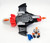 Fisher-Price® Imaginext® 2014 Alpha Star, toy spaceship with red, black, gray, and orange colors, along with a small action figure with orange hair, white suit, and blue accessories placed beside it.