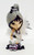 The Hamilton Collection 2014 Enchanting Companions Midnight Dream figurine, a whimsical doll with large eyes, silver and purple hair styled in a bun with purple flowers, dressed in a dark outfit with striped leggings, holding a white fox adorned with feathers and a silver tail.
