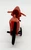 Unbranded Vintage Red Plastic Motorcycle, front view of small red plastic toy motorcycle with black wheels on a plain white background.