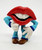 TANG Tang Trio 1989 Three Cheers Hot Lips PVC Toy Figure, colorful cartoon character with red lips, white teeth, dressed in blue jacket, white gloves, and brown shoes, striking a playful pose.