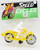 Speed Cycles Vintage Speed Cycles Toy Motorcycle - Yellow, yellow toy motorcycle with a rider figurine in a plastic packaging.