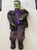 Gemmy 36 inch Frankenstein Hanging Halloween Decor, large green Frankenstein face with stitched scars, wearing a dark suit and purple shirt, with outstretched arms, for spooky Halloween decoration.