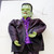 Gemmy 36 inch Frankenstein Hanging Halloween decor, a spooky Halloween decoration featuring a large Frankenstein figure with green face, black hair, purple shirt, and black jacket, suitable for Halloween parties.