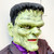 Gemmy 36" Frankenstein Hanging Halloween decor, a spooky green Frankenstein mask with black hair, yellowish skin, and a scary expression, perfect for Halloween decorations.