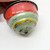 Gibbs Vintage Gibbs Tin Litho Toy Top, colorful vintage tin toy with red, green, yellow, and black paint, showing signs of wear and age.