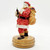 Willitts 1989 Coca-Cola Santa Claus Holding Coke Bottle Figurine, collectible Santa figurine with traditional red suit and large sack of gifts, standing on a wooden base.