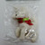 King Importing Inc. Holiday Cheer Winter Wonderland Unicorn Christmas Ornament, white unicorn with a red and green ribbon around its neck inside a clear plastic bag.