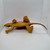 Dor Mei 1986 Edaphosaurus Rubber 15" Toy Dinosaur Figure, a detailed yellow rubber toy dinosaur with textured skin, small frills on its back, and a long tail, displayed on a white surface.