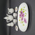 Royal Norfolk Miniature Porcelain Tea Set For Two - Morning Glory Flowers, this set includes a large oval serving tray with pink morning glory flowers, two tea cups, two small plates with matching flower designs, and a creamer and teapot, all made of white porcelain with floral accents.
