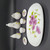 Royal Norfolk Miniature Porcelain Tea Set For Two - Morning Glory Flowers, intricate white porcelain tea set with pink morning glory floral designs on a black surface.