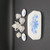 Fishel Toys Miniature China Tea Set For Two - Blue Floral, a small dollhouse porcelain tea set with two cups, a teapot, sugar bowl, creamer, and a rectangular tray, all decorated with delicate blue floral patterns.