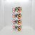 Whirley Industries Christmas Noel 10 oz. Mug Sleeve, stack of holiday-themed mug sleeves featuring Christmas trees, candy canes, poinsettias, and rocking horses.