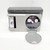 Benchmark Industries Coca-Cola NASCAR Rotating Torch Clock, vintage analog clock with rotating torch design and carbon monoxide detector, in silver color, with protective cover and accompanying box.