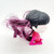 McDonald's Happy Meal Toy 2015 Monster High #6 Make Up Artist Toy, featuring a stylized doll with black hair and purple streaks, wearing a pink outfit and sitting in a kneeling position.
